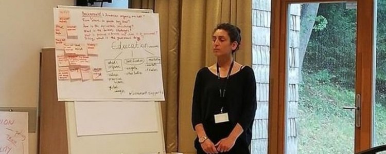 Margarit Tigranyan, a university lecturer from Armenia,  in front of a flipchart during the Organic Leadership Course in Lithuania