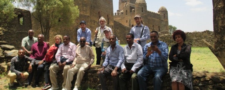 Group of people posing for a picture in front of a castle