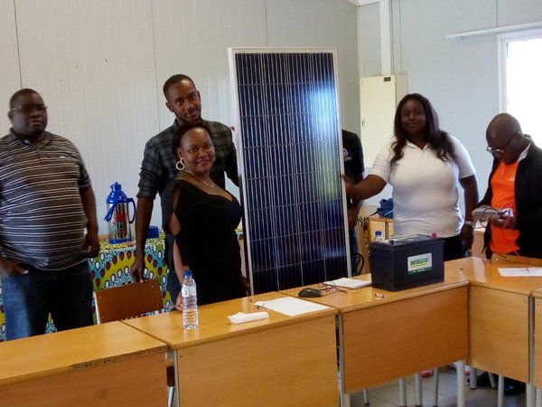 participants of workshop present large photovoltaic module