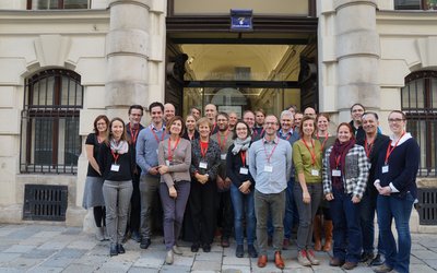 Group picture of 20 people standing in front of the OeAD