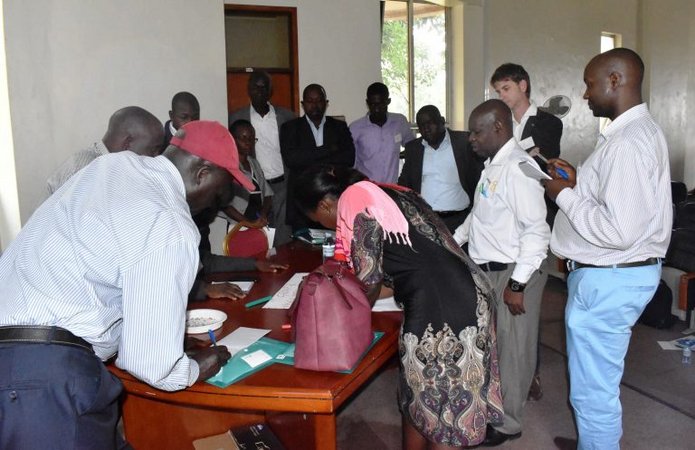 People standing around a table and talking to each other