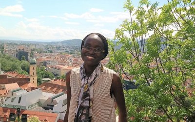 portrait of appear scholar Risper Ondiek with view over city