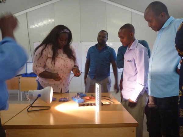 Participants of workshop looking at a photovoltaic module