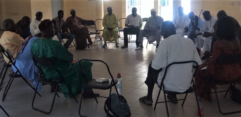 Group of people sitting on chairs arranged in a circle